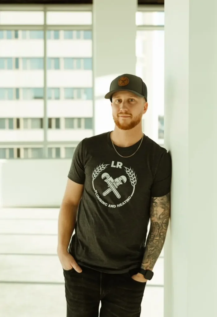 Image of team member Jordan standing and smiling